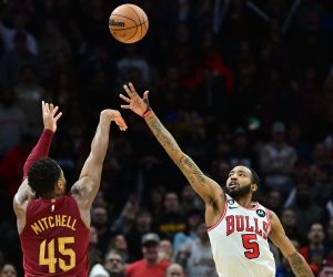 Jan 2, 2023; Cleveland, Ohio, USA; Cleveland Cavaliers guard Donovan Mitchell (45) shoots a three point shot as Chicago Bulls forward Derrick Jones Jr. (5) defends during overtime against the Chicago Bulls at Rocket Mortgage FieldHouse. Mitchell set the franchise record for points with 71. Mandatory Credit: Ken Blaze-USA TODAY Sports Photo: Ken Blaze/REUTERS
