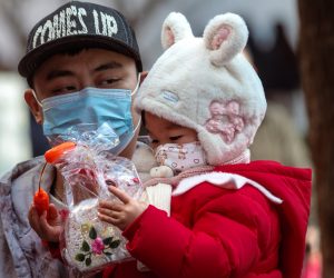 epa10415066 A man carries a child holding a toy for the Chinese New Year in Shanghai, China, 19 January 2023. Chinese New Year is the time of the world's largest human migration. Hundreds of millions of people travel back to their hometowns to celebrate and spend time with their families. According to the Chinese Lunar Calendar, 2023 begins on 22 January and represents the year of the Rabbit.  EPA/ALEX PLAVEVSKI