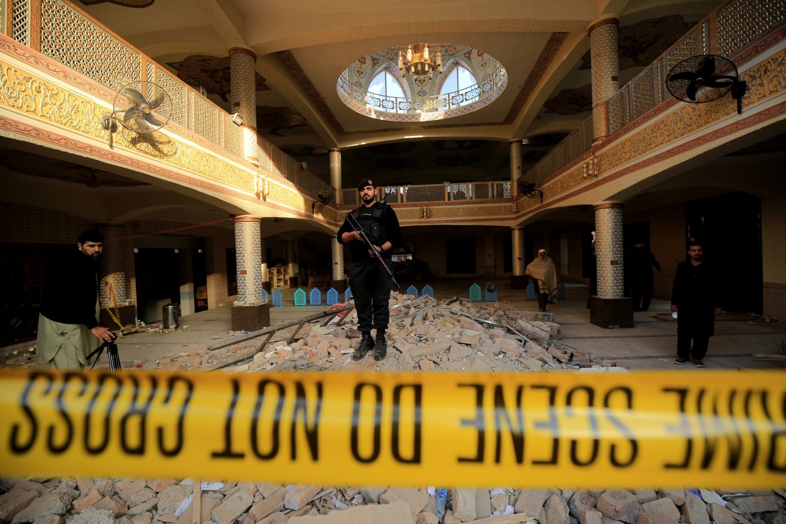 epaselect epa10441270 An armed Pakistani security official stands guard at the scene a day after a suicide bomb blast at a Mosque in Police Lines, in Peshawar, KPK province, Pakistan, 31 January 2023. The death toll from the suicide bombing has reached 92, police said on 31 January. Most of the deceased in the attack, one of the deadliest ever staged on law enforcement authorities in Pakistan's history, are police and other members of the security forces.  EPA/ARSHAD ARBAB