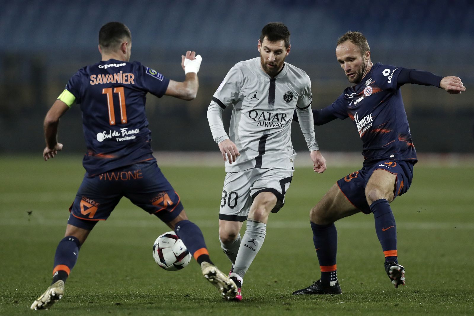 epa10443324 Paris Saint Germain's Lionel Messi (C) in action against Montpellier's Teji Savanier (L) and  Valere Germain (R) during the French Ligue 1 soccer match between Montpellier HSC and Paris Saint Germain, at La Mosson stadium, Montpellier, France, 01 February 2023.  EPA/Guillaume Horcajuelo