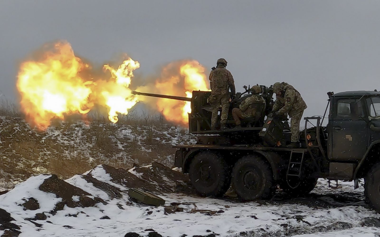 epa10447981 Ukrainian soldiers fire an anti-aircraft gun at a position near Bakhmut, Donetsk region, eastern Ukraine, 04 February 2023, amid Russia's invasion. Ukrainian servicemen have mounted a Soviet-era S-60 anti-aircraft gun on a truck for better mobility and fighting performance. The front-line city of Bakhmut, a key target for Russian forces, has seen heavy fighting for months. Russian troops on 24 February 2022, entered Ukrainian territory, starting a conflict that has provoked destruction and a humanitarian crisis.  EPA/SERGEY SHESTAK