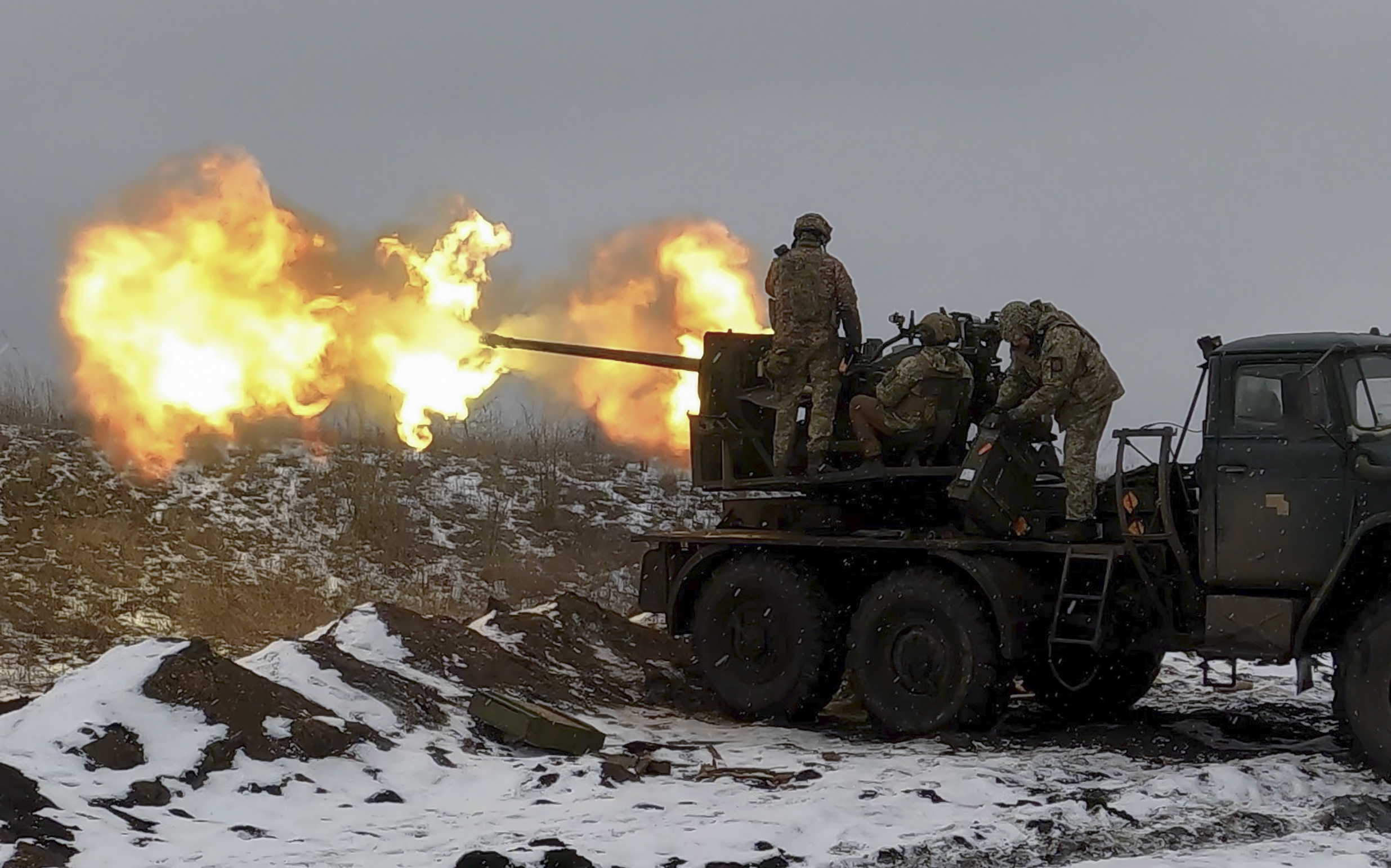 epa10447981 Ukrainian soldiers fire an anti-aircraft gun at a position near Bakhmut, Donetsk region, eastern Ukraine, 04 February 2023, amid Russia's invasion. Ukrainian servicemen have mounted a Soviet-era S-60 anti-aircraft gun on a truck for better mobility and fighting performance. The front-line city of Bakhmut, a key target for Russian forces, has seen heavy fighting for months. Russian troops on 24 February 2022, entered Ukrainian territory, starting a conflict that has provoked destruction and a humanitarian crisis.  EPA/SERGEY SHESTAK