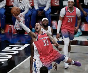 epa10448172 Washington Wizards forward Kyle Kuzma (C) shoots over Brooklyn Nets defenders during the first half of the NBA basketball game between the Washington Wizards and Brooklyn Nets at the Barclays Center in Brooklyn, New York, USA, 04 February 2023.  EPA/Peter Foley SHUTTERSTOCK OUT