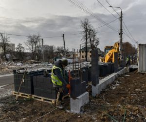 epa10461182 Construction workers build a new house for the old one that was destroyed by shelling in Bucha town, Kyiv region, Ukraine, 11 February 2023. Russian troops entered Ukraine on 24 February resulting in fighting and destruction in the country and triggering a series of severe economic sanctions on Russia by Western countries.  EPA/OLEG PETRASYUK