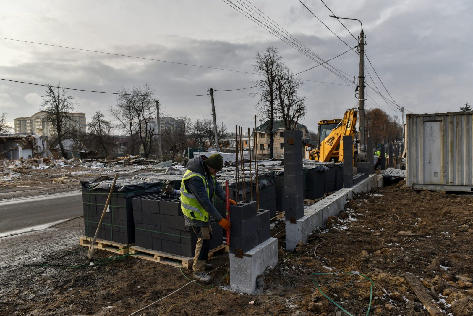 epa10461182 Construction workers build a new house for the old one that was destroyed by shelling in Bucha town, Kyiv region, Ukraine, 11 February 2023. Russian troops entered Ukraine on 24 February resulting in fighting and destruction in the country and triggering a series of severe economic sanctions on Russia by Western countries.  EPA/OLEG PETRASYUK