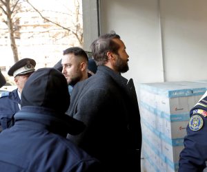 epa10464608 Tristan Tate (C), the brother of former professional kickboxer and social media influencer Andrew Tate (not pictured) is escorted by police officers to the Directorate for Investigating Organized Crime and Terrorism (DIICOT) headquarters to be questioned in Bucharest, Romania, 13 February 2023. On 29 December 2022, Andrew Tate and his brother Tristan were arrested as a result of the DIICOT inquiry under the charges of human trafficking and intention to form an organized crime group. Romanian police stated that the two brothers and their associates coerced victims for creating a paid pornography service for social media platforms.  EPA/ROBERT GHEMENT