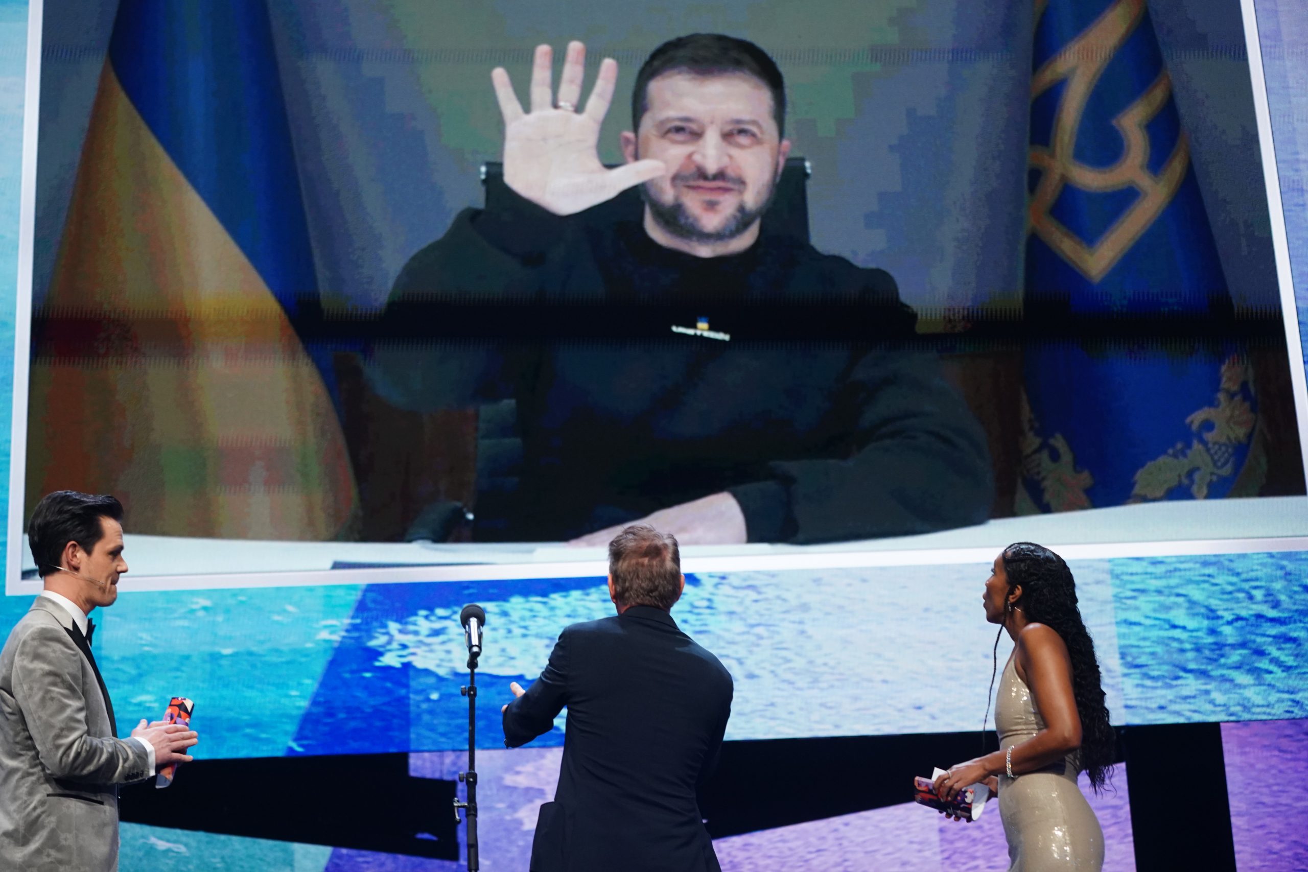 epa10471407 Ukraine's President Volodymyr Zelensky appears on screen at the Opening Ceremony of the 73rd Berlin International Film Festival 'Berlinale' in Berlin, Germany, 16 February 2023. The in-person event runs from 16 to 26 February 2023.  EPA/CLEMENS BILAN
