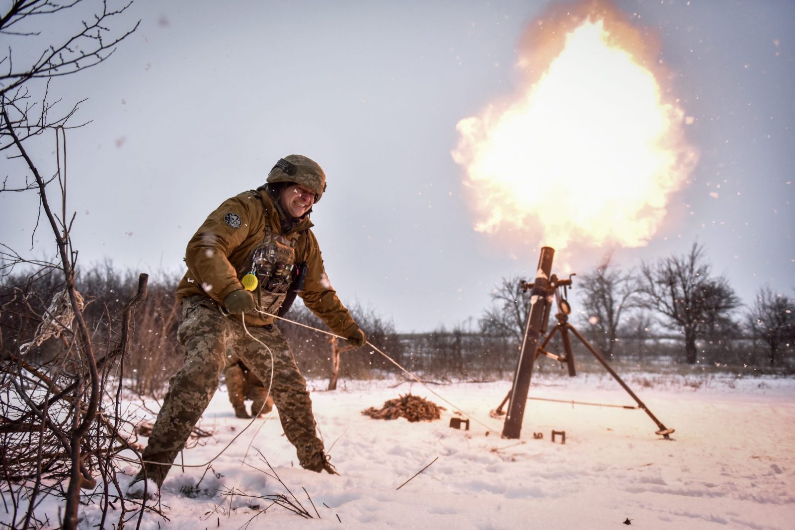 epa10473561 Ukrainian serviceman of the " 24 separate mechanized brigade named after King Danylo" fires a mortar towards Russian positions, at an undisclosed location, Donetsk region, eastern Ukraine, 17 February 2023.  Russian troops entered Ukraine on 24 February 2022 starting a conflict that has provoked destruction and a humanitarian crisis.  EPA/OLEG PETRASYUK