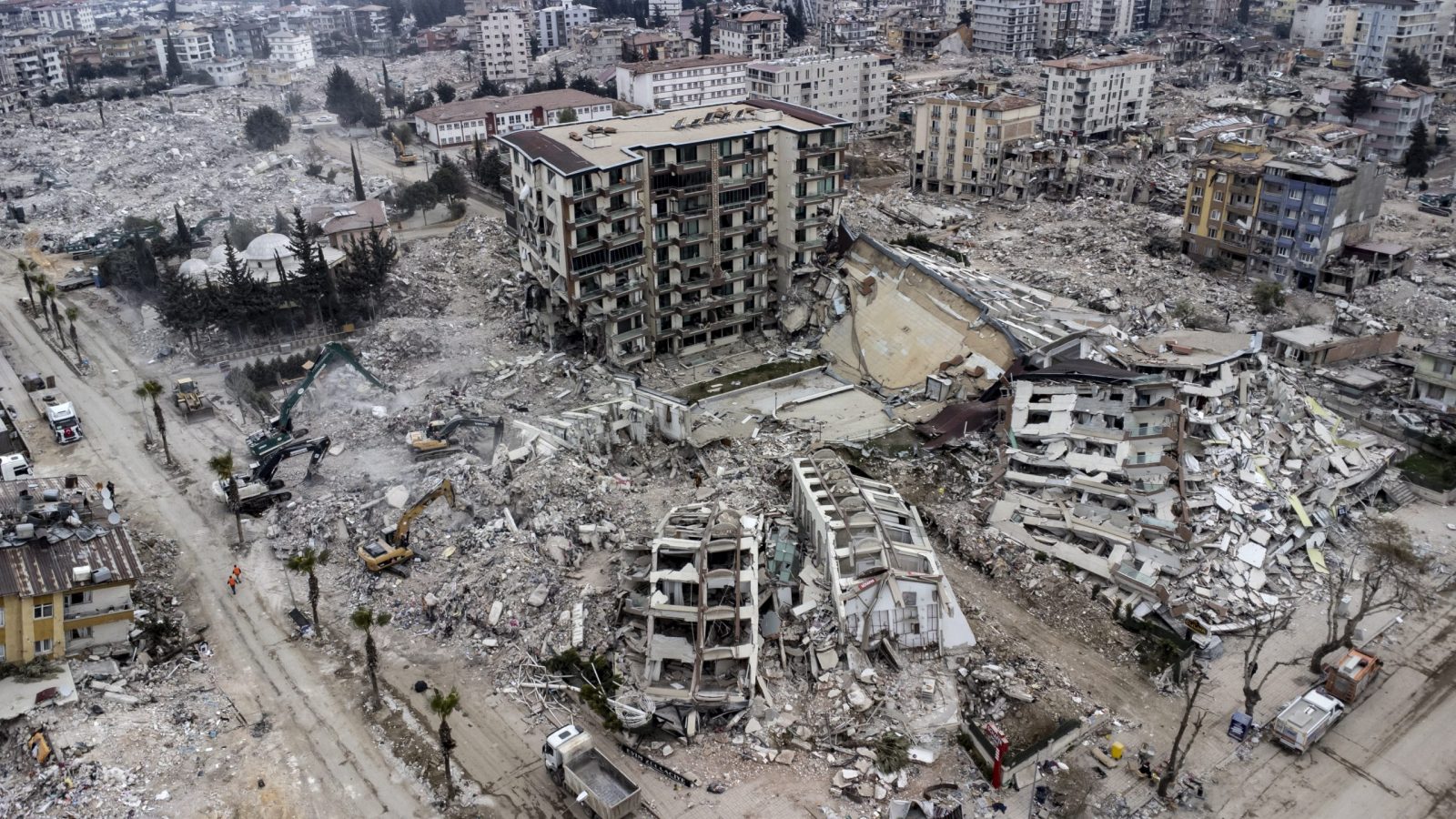 epa10481770 An aerial view taken with a drone shows, a view of collapsed buildings after a powerful earthquake in Hatay, Turkey, 21 February 2023. More than 46,000 people have died and thousands more are injured after two major earthquakes struck southern Turkey and northern Syria on 06 February.  EPA/ERDEM SAHIN