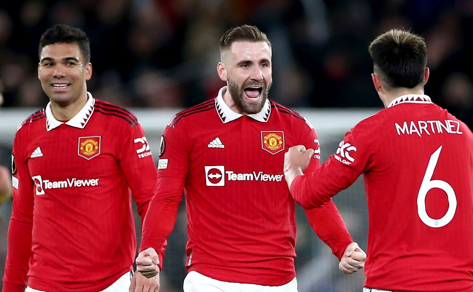 epa10486832 Luke Shaw (C) of Manchester United celebrates with teammates Casemiro (L) and Lisandro Martinez after the UEFA Europa League play-off, 2nd leg match between Manchester United and FC Barcelona in Manchester, Britain, 23 February 2023. Manchester United won 2-1 and knocked Barcelona out of the competition.  EPA/Adam Vaughan