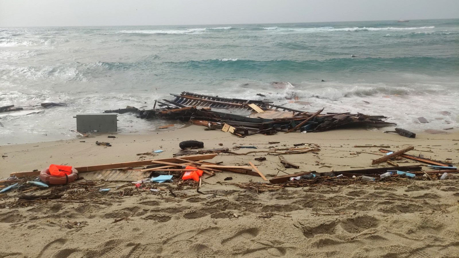 epa10491819 Debris washed ashore at a beach near Cutro, Crotone province, southern Italy, 26 February 2023. Italian authorities said on 26 February that at least 30 bodies were found on the beach and in the sea near Crotone, in the southern Italian region of Calabria, after a boat carrying migrants sank in rough seas near the coast. About forty people survived the accident, Italian firefighters added. Authorities fear the death toll will climb as rescuers look for survivors.  EPA/GIUSEPPE PIPITA