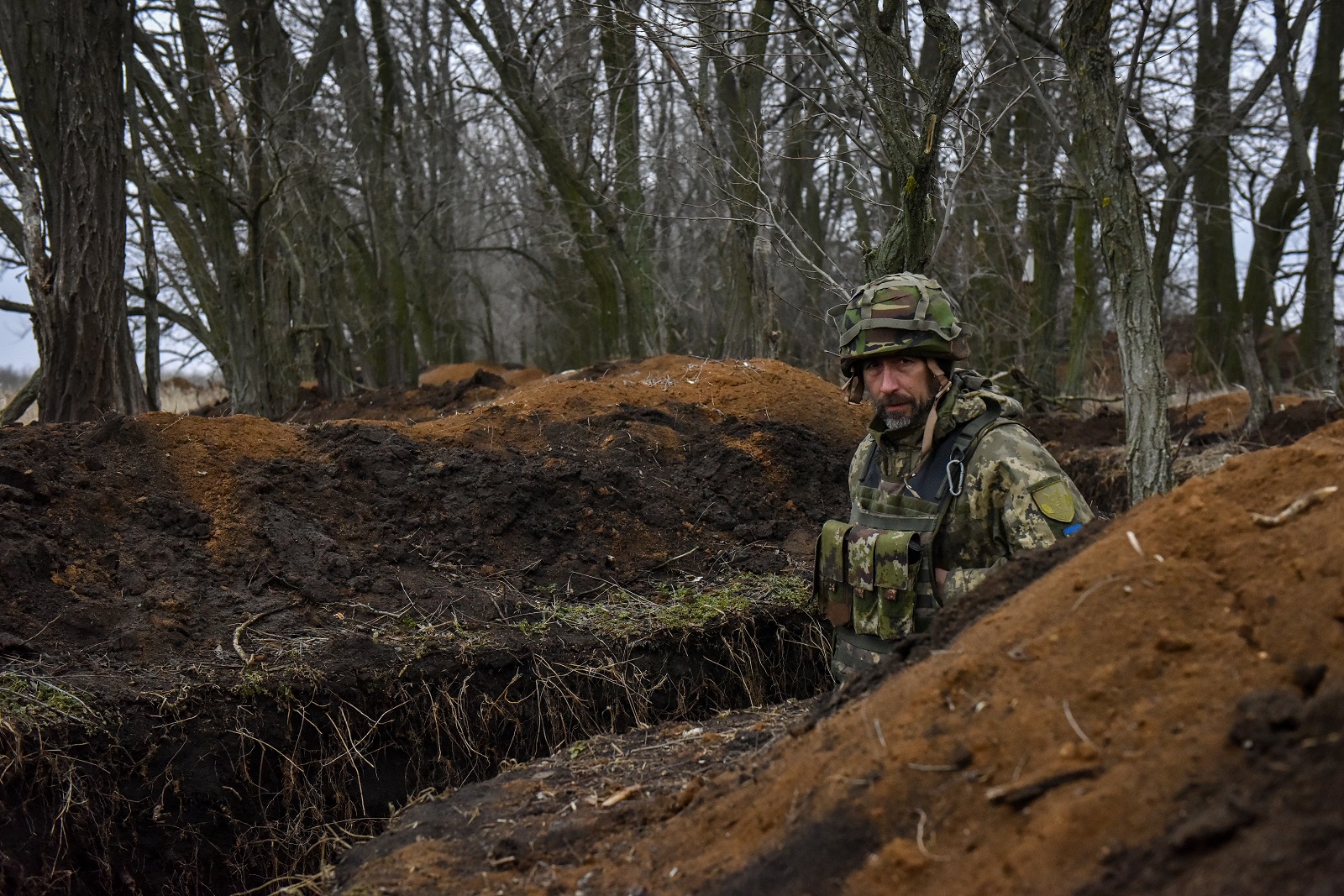 epa10492896 A Ukrainian serviceman of the 68th Separate Jager Infantry Brigade "Oleksa Dovbush" walks in a trench on a frontline position at an undisclosed location in the Donetsk region, eastern Ukraine, 26 February 2023. Russian troops entered Ukraine on 24 February 2022 starting a conflict that has provoked destruction and a humanitarian crisis.  EPA/OLEG PETRASYUK