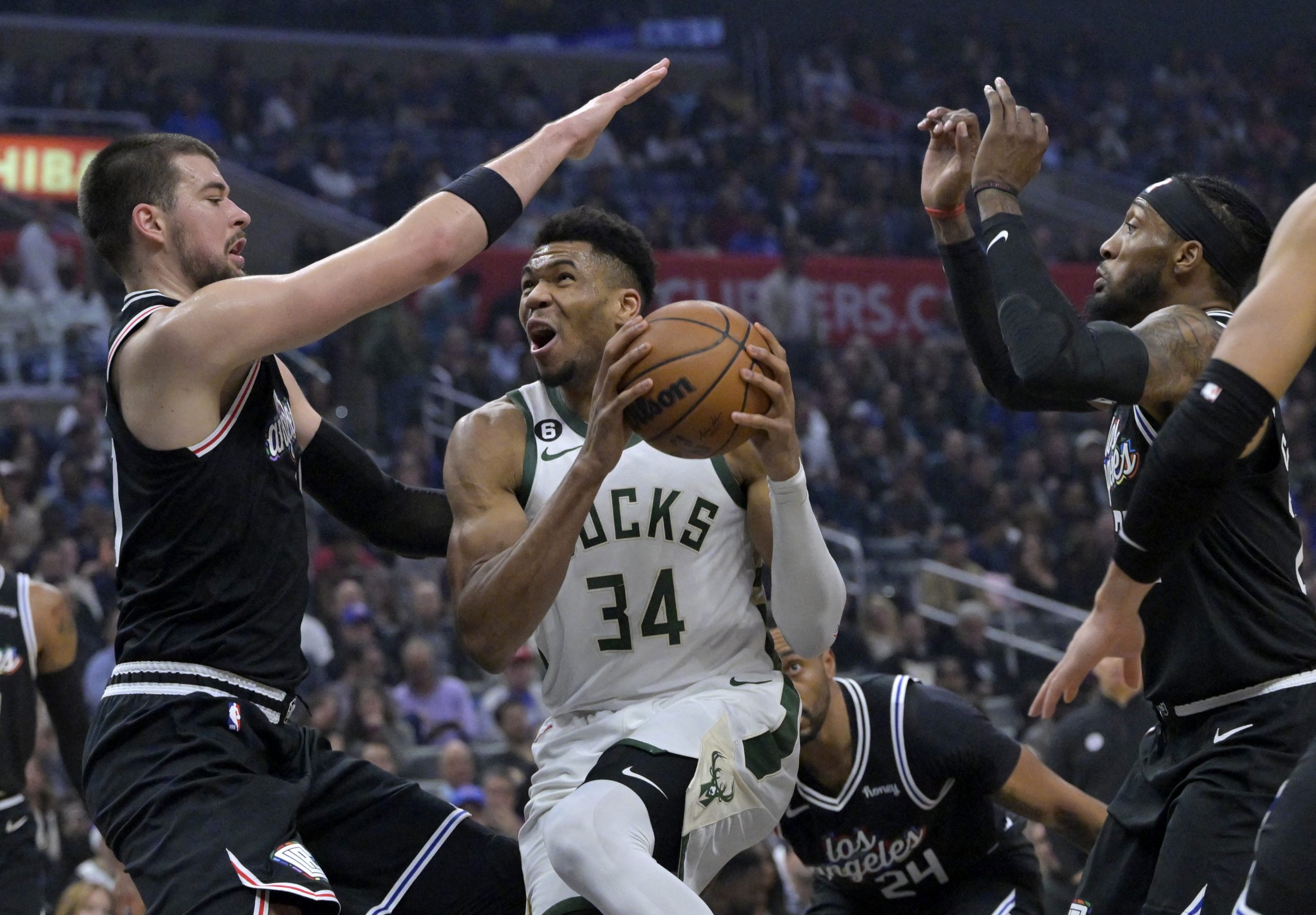 Feb 10, 2023; Los Angeles, California, USA;  Milwaukee Bucks forward Giannis Antetokounmpo (34) drives past Los Angeles Clippers center Ivica Zubac (40) and forward Robert Covington (23) for a basket in the first half at Crypto.com Arena. Mandatory Credit: Jayne Kamin-Oncea-USA TODAY Sports Photo: Jayne Kamin-Oncea/REUTERS