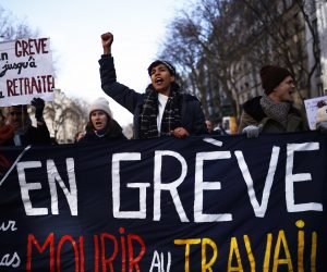 epa10441335 Demonstrators hold a banner reading 'On strike so as not to die at work' as thousands of protesters take part in a demonstration against the government's reform of the pension system, in Paris, France, 31 January 2023. The French government plans to raise the minimum retirement age from 62 to 64 by 2030.  EPA/YOAN VALAT