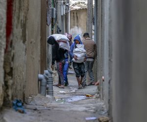 epa10444497 Palestinian refugees carry bags at an alley in Deir Al Balah refugee in the southern Gaza Strip, 02 February 2023. Israel launched air strikes on the Gaza Strip early 02 February, hours after the Israeli forces said they intercepted a rocket fired from the Palestinian territory.  EPA/MOHAMMED SABER