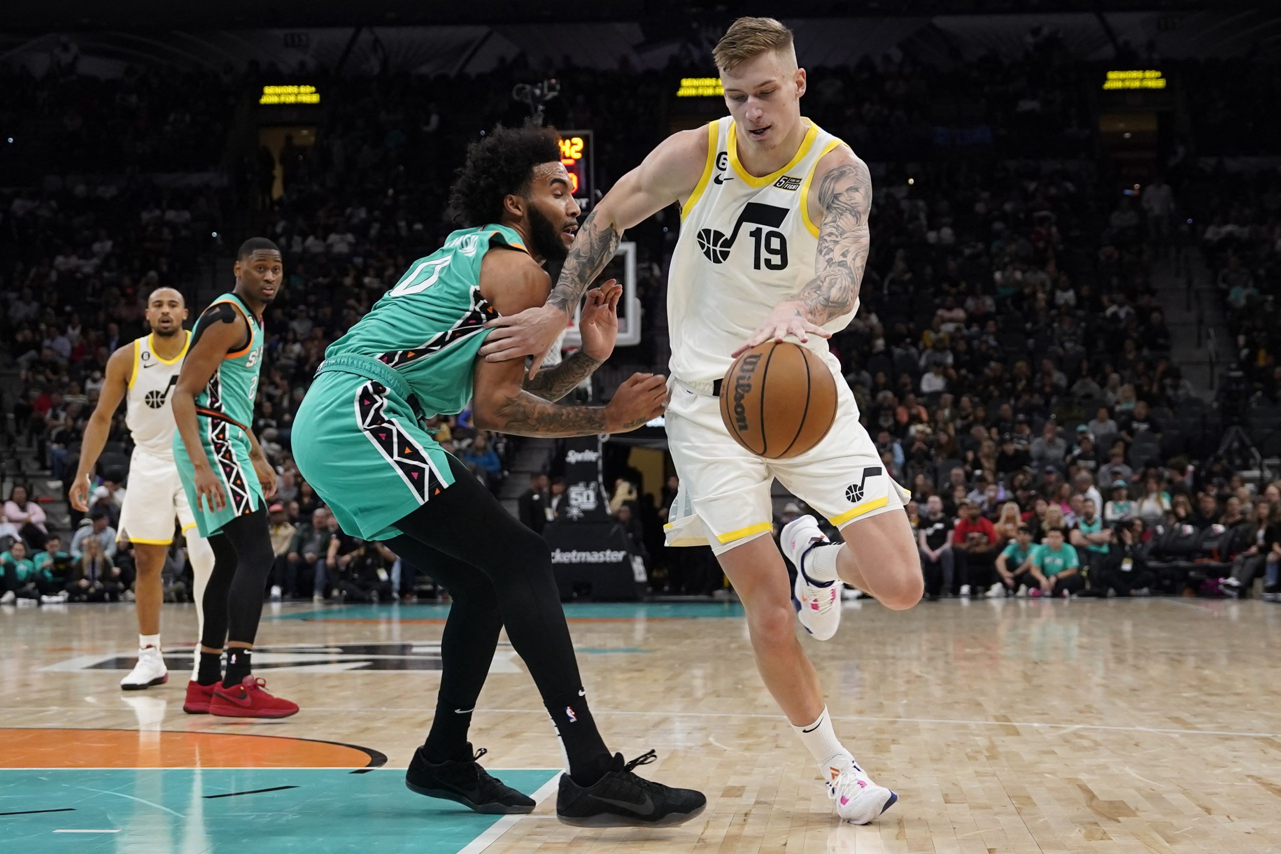 Mar 29, 2023; San Antonio, Texas, USA; Utah Jazz forward Luka Samanic (19) drives to the basket against San Antonio Spurs forward Julian Champaigne (30) during the first half at AT&T Center. Mandatory Credit: Scott Wachter-USA TODAY Sports