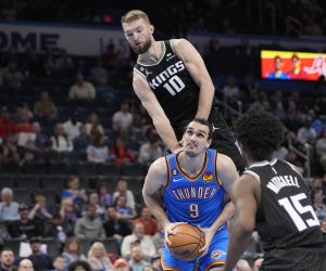 Oklahoma City Thunder forward Dario Saric (9) is fouled by Sacramento Kings forward Domantas Sabonis (10) in the second half of an NBA basketball game Tuesday, Feb. 28, 2023, in Oklahoma City. (AP Photo/Sue Ogrocki)