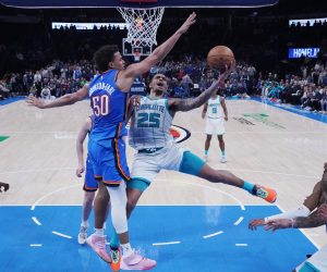 Charlotte Hornets' forward P.J. Washington (25) shoots as Oklahoma City Thunder forward Jeremiah Robinson-Earl (50) defends in the second half of an NBA basketball game Tuesday, March 28, 2023, in Oklahoma City. (AP Photo/Sue Ogrocki)