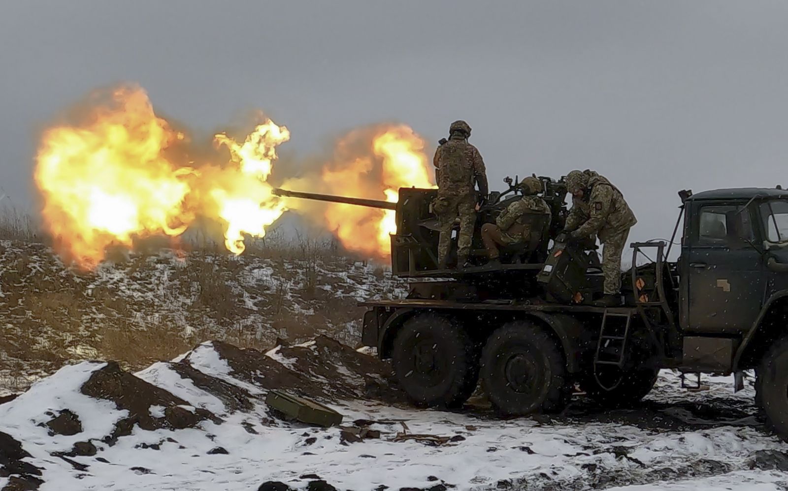 epa10447981 Ukrainian soldiers fire an anti-aircraft gun at a position near Bakhmut, Donetsk region, eastern Ukraine, 04 February 2023, amid Russia's invasion. Ukrainian servicemen have mounted a Soviet-era S-60 anti-aircraft gun on a truck for better mobility and fighting performance. The front-line city of Bakhmut, a key target for Russian forces, has seen heavy fighting for months. Russian troops on 24 February 2022, entered Ukrainian territory, starting a conflict that has provoked destruction and a humanitarian crisis.  EPA/SERGEY SHESTAK