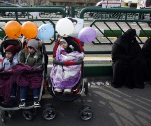 epa10460371 Iranian women sit next to their child during the 44th anniversary of the 1979 Islamic Revolution, at the Azadi (Freedom) square in Tehran, Iran, 11 February 2023. The event marks the 44th anniversary of the Islamic revolution, which came ten days after Ayatollah Ruhollah Khomeini's returned from his exile in Paris to Iran, toppling the monarchy system and forming the Islamic Republic  EPA/ABEDIN TAHERKENAREH