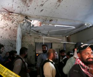 epa10473527 Pakistani security officials inspect the scene of an attack by gunmen targeting the office of the Karachi Police chief, in Karachi, Pakistan, 17 February 2023. According to police, at least three police officials were killed and 11 were injured after gunmen attacked the office of the Karachi police chief located on Main Sharea Faisal, with an operation currently underway.  EPA/REHAN KHAN