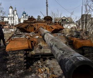 epa10488278 A man walks past a destroyed Russian tank in Sviatohirsk, Donetsk region, eastern Ukraine, 24 February 2023. Russian troops entered Ukrainian territory on 24 February 2022, starting a conflict that has provoked destruction and a humanitarian crisis. One year on, fighting continues in many parts of the country.  EPA/OLEG PETRASYUK