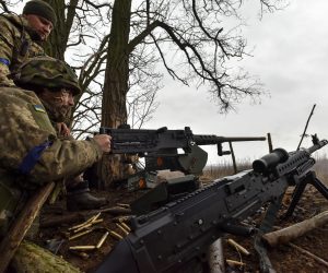 epa10492897 Ukrainian servicemen of the 68th Separate Jager Infantry Brigade "Oleksa Dovbush" fire an M2 machine gun on a frontline position at an undisclosed location in the Donetsk region, eastern Ukraine, 26 February 2023. Russian troops entered Ukraine on 24 February 2022 starting a conflict that has provoked destruction and a humanitarian crisis.  EPA/OLEG PETRASYUK