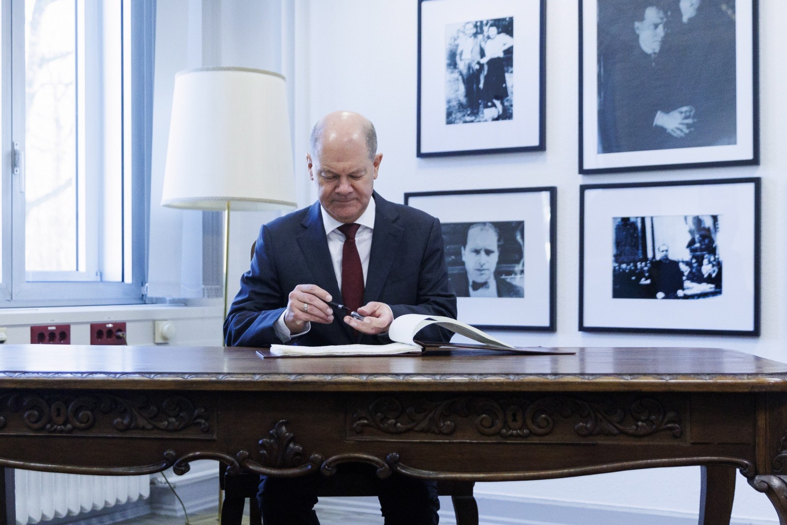 epa10494938 German Chancellor Olaf Scholz after signing the guest book during a visit at the territorial defence command of the Bundeswehr, Germany's armed forces, in Berlin, Germany, 28 February 2023. The command was reformed last year to introduce a more centralized command structure for the Bundeswehr's domestic roles, including a better preparedness for hybrid destabilization attempts. The creation of the new command was in part a reaction to Russia's ongoing war in Ukraine.  EPA/Carsten Koall / POOL