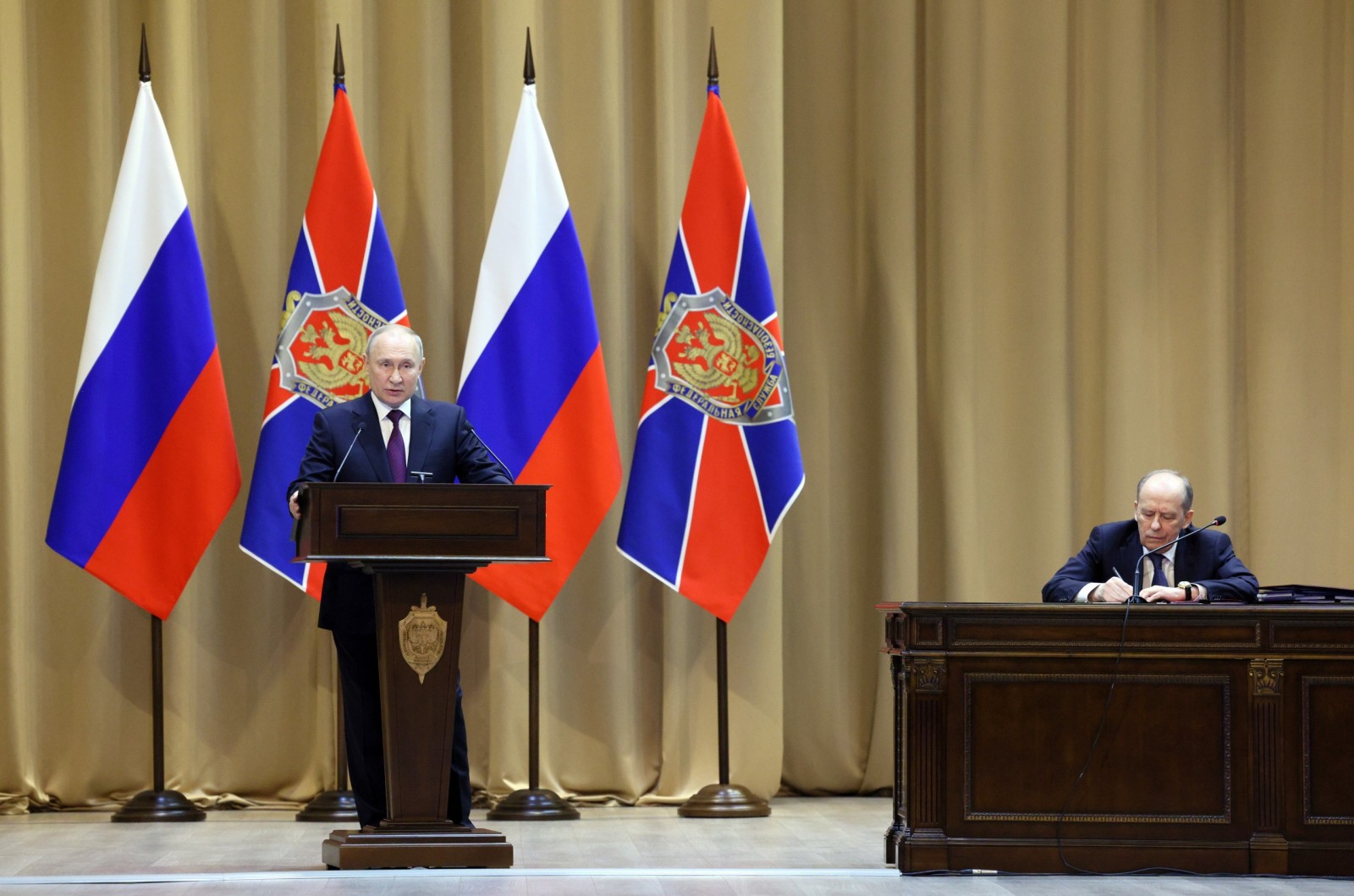 epa10495406 Russian President Vladimir Putin (L) delivers his speech as Russian Federal Security Service (FSB) Director Aleksandr Bortnikov (R) attends a meeting of the Federal Security Service (FSB) Board which sums up the 2022 performance of the FSB bodies and outlines the priority tasks for 2023, in Moscow, Russia, 28 February 2023. 'Together with law enforcement agencies and under the coordination of the national anti-terrorist committee, it is necessary to act decisively and offensively, use the entire arsenal of operational, analytical and other means. and the fuel and energy complex,' the president said at the expanded board of the FSB of Russia.  EPA/GAVRIIL GRIGOROV/SPUTNIK/KREMLIN POOL / MANDATORY CREDIT