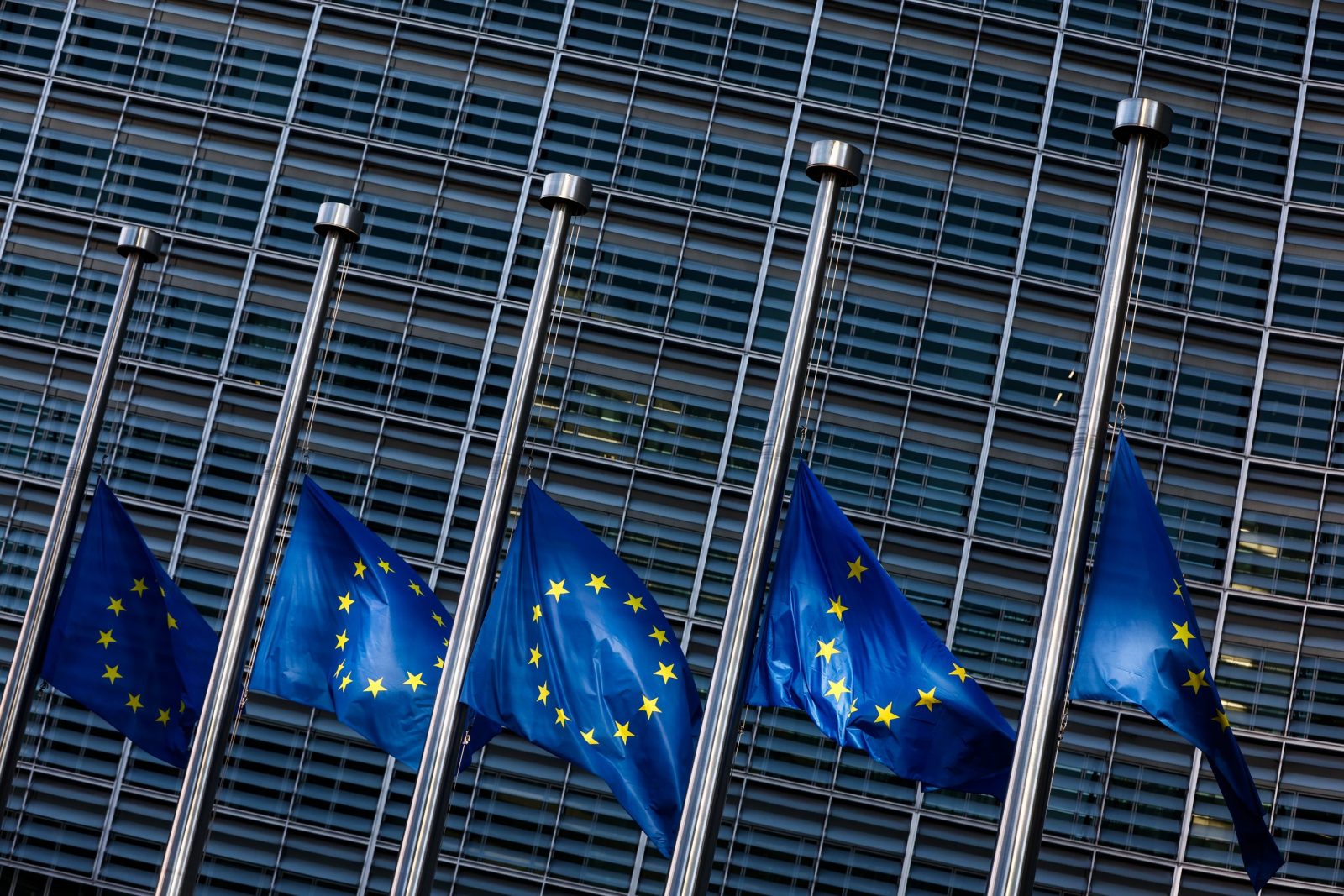 epa10496789 European flags at half mast after train collision in Greece at the European Commission headquarters in Brussels, Belgium, 01 March 2023. A head-on collision between a passenger train and a freight train near Larissa in Greece has left at least 36 people dead.  EPA/STEPHANIE LECOCQ