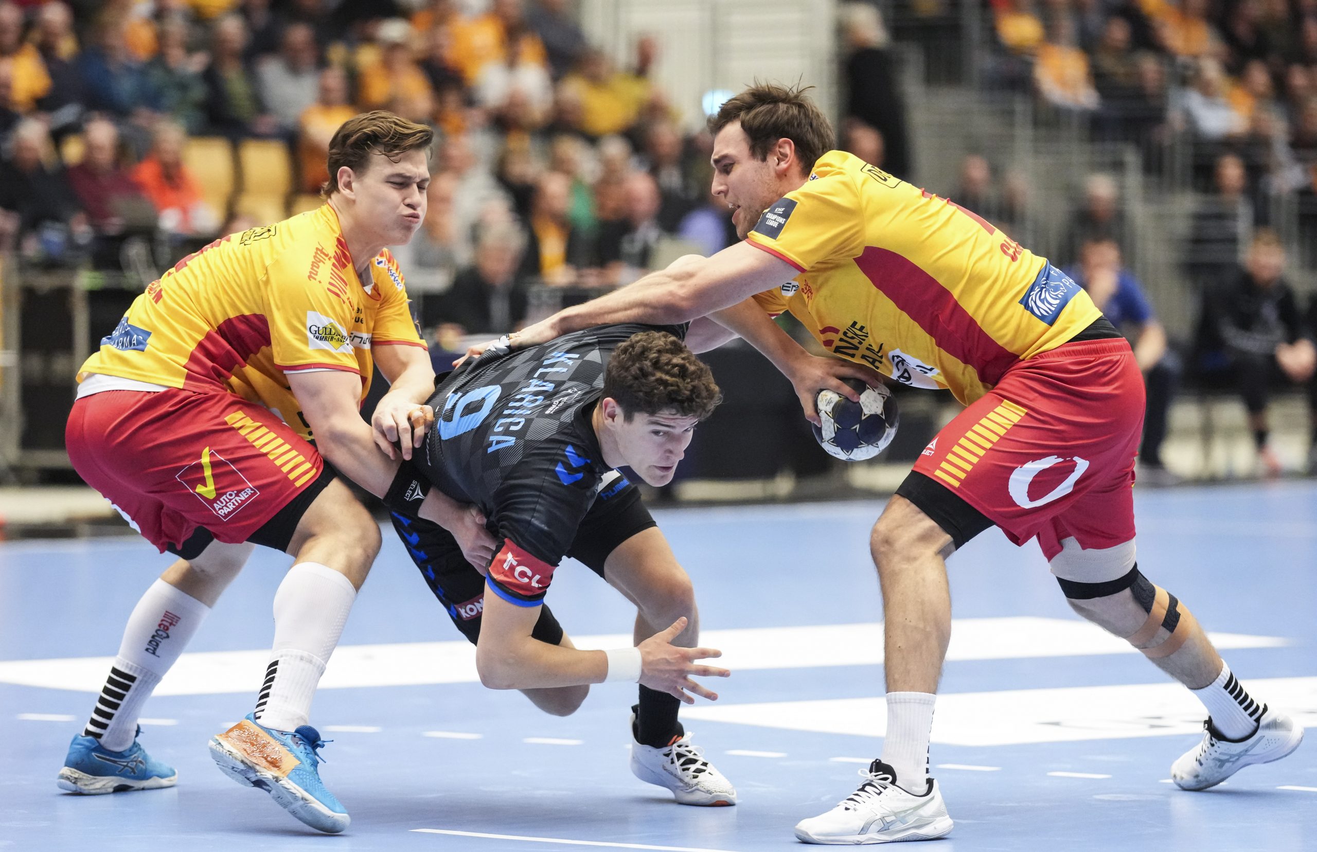 epa10497677 Luka Lovre Klarica (Zagreb 9) against Lukas Joergensen (GOG 14) and Frederik Clausen (GOG 77) during the Champions League men's handball match between GOG and HC PPD Zagreb in Odense, Denmark, 01 March 2023.  EPA/Claus Fisker DENMARK OUT