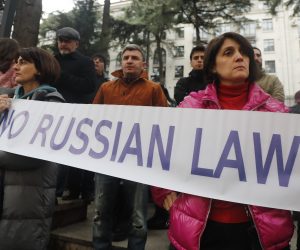 epa10506213 People hold a banner as they take part in a rally to protest the so-called 'Foreign Agents Law' which the Georgian Parliament is going to adopt in the future, in front of the Parliament building in Tbilisi, Georgia, 06 March 2023. The law says that a Georgian legal entity, which is more than 20 percent funded from abroad, must be considered as an agent of foreign influence and has to register with the Georgian Ministry of Justice.  EPA/ZURAB KURTSIKIDZE