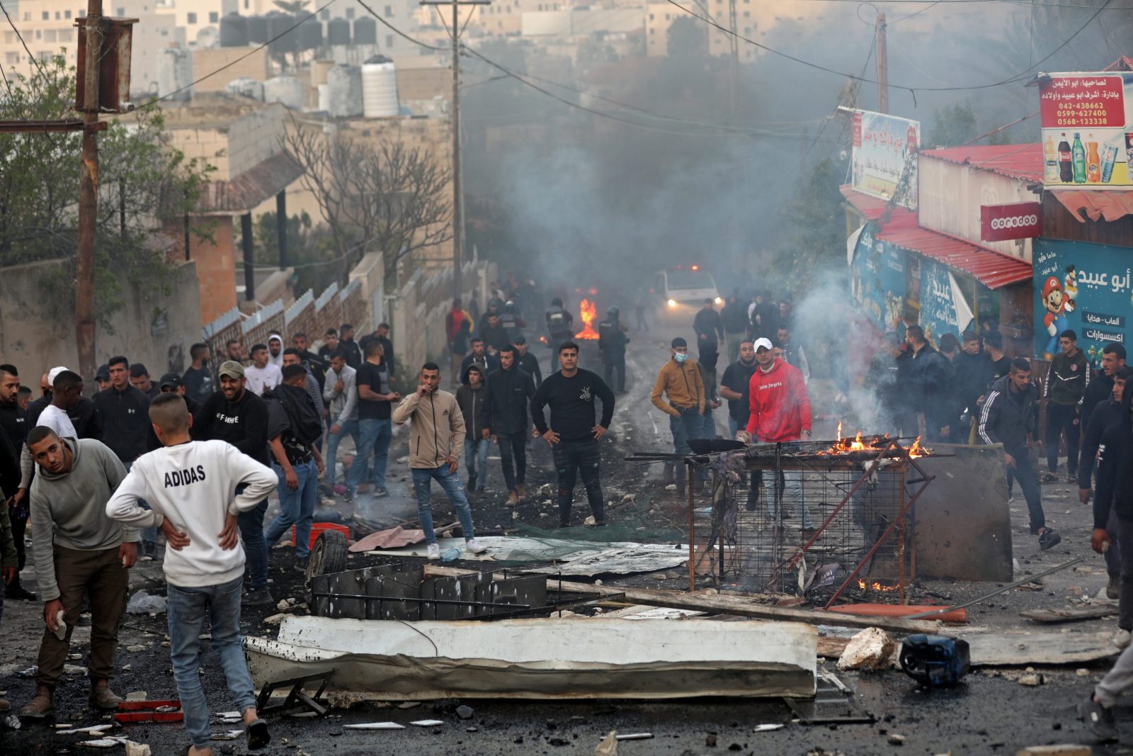 epa10507850 Palestinians clash with Israeli troops during a raid by the Israeli army in the West Bank town of Jenin, 07 March 2023. According to the Palestinian Authority’s health ministry, at least six Palestinians were killed and 11 wounded during the raid. An Israeli army spokesperson announced that security forces operating in the Jenin camp killed the suspect of the shooting attack in Hawara on 26 February.  EPA/ALAA BADARNEH