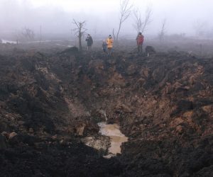 epaselect epa10511280 Locals gather around a shelling crater after a rocket hit the Pisochyn neighborhood outside Kharkiv, Ukraine, 09 March 2023. Ukrainian authorities said on 09 March that Russia fired 81 missiles across the country targeting critical infrastructure and residential buildings. The country's Defense Ministry confirmed that 34 cruise missiles were shot down. According to Ukraine's nuclear operator Energoatom, the Zaporizhzhia nuclear power plant (NPP) lost power as a result of the missile attacks, and was running on diesel generators.  EPA/PAVLO PAKHOMENKO
