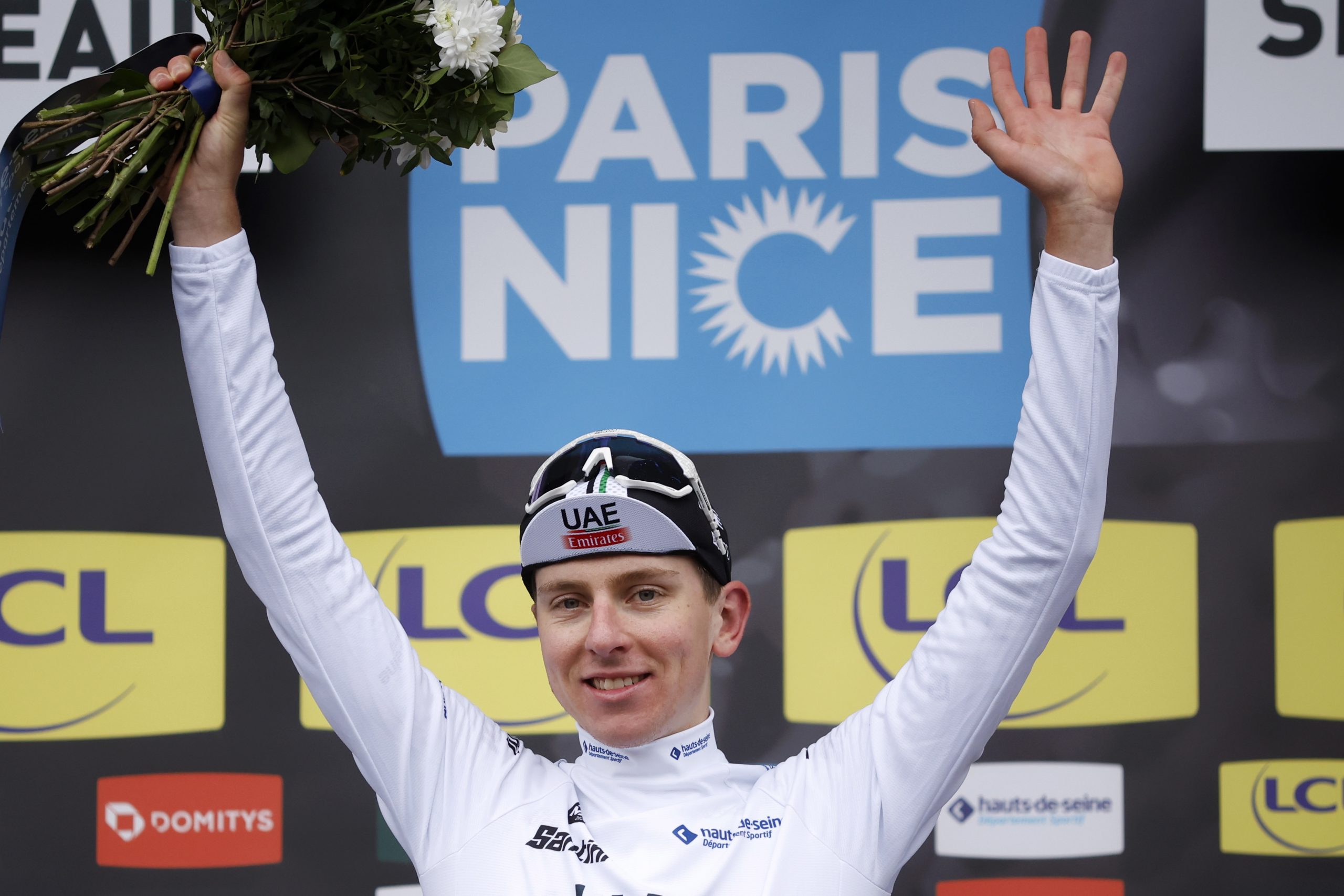 epa10506361 Slovenian rider Tadej Pogacar UAE Team Emirates celebrates on the podium retaining the best young rider's white jersey following the 2nd stage of the Paris Nice cycling race over 163.7 km from Bazainville to Fontainebleau, France, 06 March 2023.  EPA/YOAN VALAT