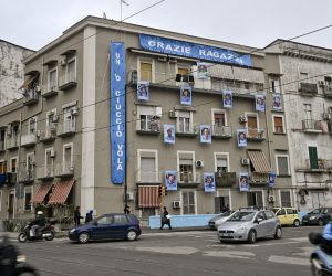 epa10513660 Pictures of 11 SSC Napoli players and their coach are arranged to look like a sticker album page along the four floors of a building's facade in the area of the central station in Naples, Italy, 10 March 2023. At thirteen rounds from the end of the Serie A soccer championship, SSC Napoli fans are already beginning to celebrate the victory of the Scudetto.  EPA/CIRO FUSCO