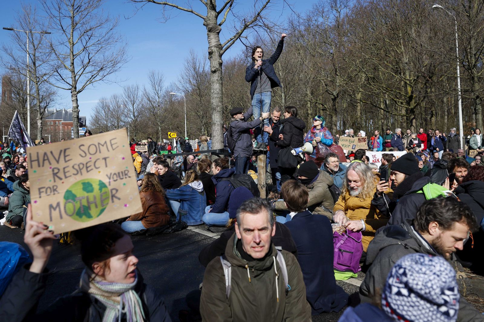 epa10514842 Climate activists from Extinction Rebellion (XR) block the A12 between the Ministry of Economic Affairs and Climate and the temporary House of Representatives in The Hague, the Netherlands, 11 March 2023.  EPA/SEM VAN DER WAL