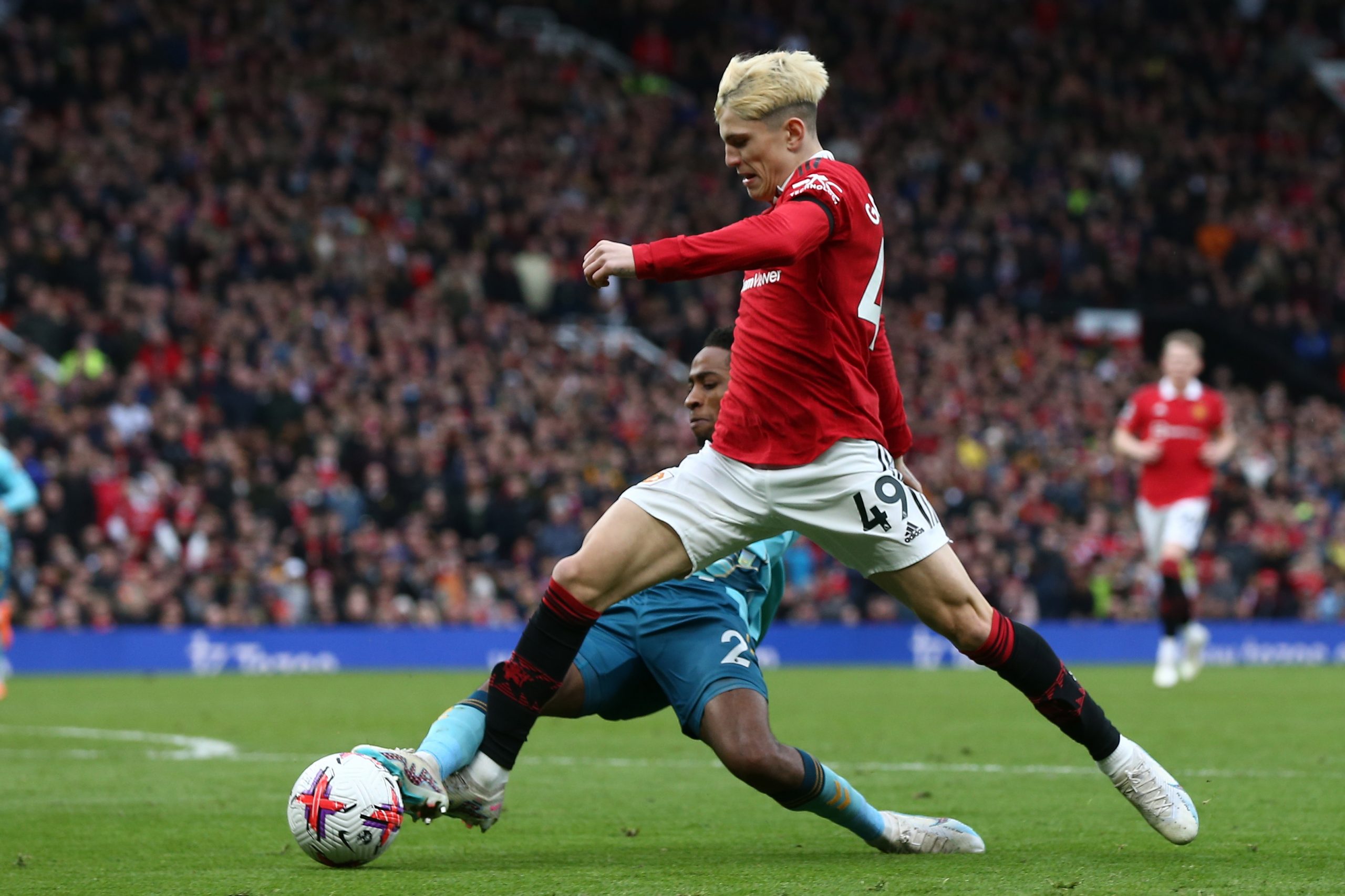 epa10517169 Alejandro Garnacho (R) of Manchester United is tackled by Kyle Walker-Peters (L) of Southampton during the English Premier League soccer match between Manchester United and Southampton in Manchester, Britain, 12 March 2023.  EPA/Adam Vaughan EDITORIAL USE ONLY. No use with unauthorized audio, video, data, fixture lists, club/league logos or 'live' services. Online in-match use limited to 120 images, no video emulation. No use in betting, games or single club/league/player publications