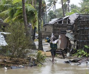 epa10517496 A man collects some wood on a flooded street near Quelimane, as the storm Freddy hits Mozambique, 12 March 2023. The provincial capital of Quelimane will be the largest urban area closest to the cyclone's point of arrival on the mainland, and its radius (of about 300 kilometres) is expected to extend from Marromeu to Pebane, then moving inland towards Cherimane and southern Malawi. This is one of the longest lasting storms ever, after it formed at the beginning of February in the Asian seas, crossing the entire Indian Ocean to the east African coast.  EPA/ANDRE CATUEIRA