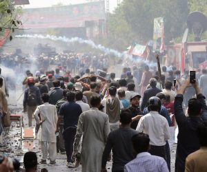 epa10524004 Supporters of former prime minister Imran Khan clash with police as they gather outside Khan's residence to resist his arrest in Lahore, Pakistan, 15 March 2023. Hundreds of PTI supporters continue to clash with riot police and rangers as they reached the residence of former prime minister Imran Khan on 15 March, to arrest the embattled politician in eastern Lahore city. Khan is accused of illegally selling state gifts from foreign dignitaries and of failing to declare them to the electoral commission among his assets. The development came a day after an Islamabad district and sessions court again issued arrest warrants for Khan after he continuously skipped hearings in the case.  EPA/RAHAT DAR 10116