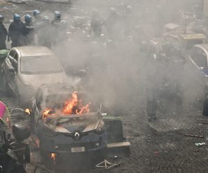 epa10524620 A police car set on fire during clashes with Eintracht Frankfurt supporters in Naples, Italy, 15 March 2023, ahead of the UEFA Champions League Round of 16, 2nd leg match between SSC Napoli and Eintracht Frankfurt.  EPA/CIRO FUSCO
