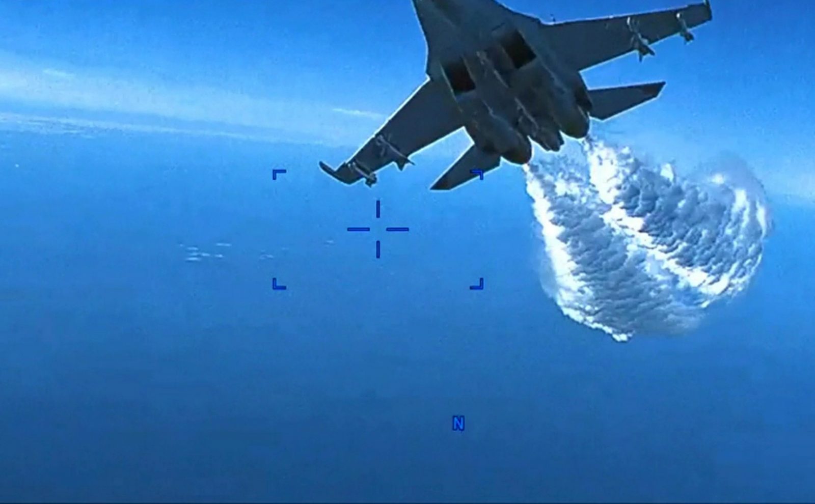epa10525960 A still images taken from a handout video made available by the US Central Command (CENTCOM) Public Affairs via the Defense Visual Information Distribution Service (DVIDS) shows a Russian Su-27 aircraft moments before droppeed fuel hits an US unmanned MQ-9 aircraft operating over the Black Sea on 14 March 2023 (issued 16 March 2024). Russian Su-27s dumped fuel upon and struck the propeller of the MQ-9, causing U.S. forces to have to bring the MQ-9 down in international waters.  EPA/US Air Force video / HANDOUT  HANDOUT EDITORIAL USE ONLY/NO SALES