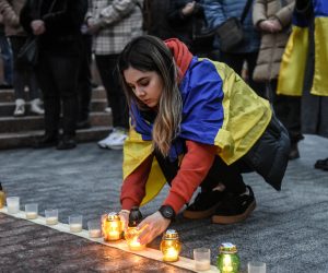 epa10526968 A woman lights candles and arranges them to form the word 'Children' as they attend a commemorative rally to mark the first anniversary of the bombing of the Mariupol Drama Theatre, in front of the National Opera of Ukraine in Kyiv (Kiev), Ukraine, 16 March 2023. The Drama Theater was destroyed on 16 March 2022 during Russian airstrikes and the siege of the southern Ukrainian port city of Mariupol. According to Amnesty International Ukraine at least 300 people died in the attack on the theatre, where a large number of civilians were hiding and the word 'Children' was written outside the building. Russian troops entered Ukrainian territory on 24 February 2022, starting a conflict that has provoked destruction and a humanitarian crisis.  EPA/OLEG PETRASYUK
