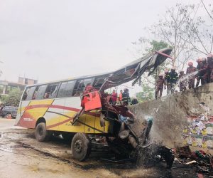 epa10531444 Firefighters hose a fire that after a road accident at Sibchar upazila in the Madaripur district in Bangladesh, 19 March 2023. At least 19 people died and many others were injured according to the firefighters in Madaripur. Police in Madaripur suspects that either a burst wheel or speeding could be the reason behind the accident.  EPA/AJOY KINDU BEST QUALITY AVAILABLE