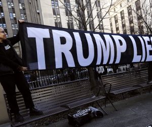 epaselect epa10535539 Demonstrators hold up a banner outside New York Criminal Court in advance of a potential Indictment of Former President Donald Trump in New York, New York, USA, 21 March 2023. Major US News organizations continue to report the likelihood that former President Donald J. Trump may be the first US President to be formally indicted on charges related to hush-money payments to porn star Stormy Daniels.  EPA/Peter Foley
