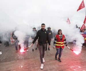 epa10538275 People hold flares during a rally against the government's reform to the pension system, in Marseille, France, 23 March 2023. Protests continue in France after the prime minister announced on 16 March 2023 the use of Article 49 paragraph 3 (49.3) of the French Constitution to have the text on the controversial pension reform law - raising retirement age from 62 to 64 - be definitively adopted without a vote.  EPA/GUILLAUME HORCAJUELO