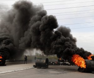 epa10541003 French union workers block access to the Fos-sur-Mer refinery during a protest against the French government's reform to the pension system, in Fos-sur-Mer, near Marseille, France, 24 March 2023. Protests continue in France after the prime minister announced on 16 March 2023 the use of Article 49 paragraph 3 (49.3) of the French Constitution to have the text on the controversial pension reform law - raising retirement age from 62 to 64 - be definitively adopted without a vote.  EPA/GUILLAUME HORCAJUELO