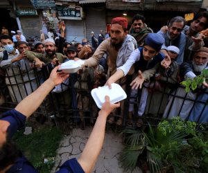epa10544515 People receive free food during the Muslims fasting month of Ramadan in Peshawar, Pakistan, 26 March 2023. Muslims around the world celebrate the holy month of Ramadan, by praying during the night time and abstaining from eating, drinking, and sexual acts during the period between sunrise and sunset. Ramadan is the ninth month in the Islamic calendar and it is believed that the revelation of the first verse in Koran was during its last 10 nights.  EPA/BILAWAL ARBAB