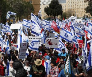 epa10545111 Protesters gather outside the Knesset ahead of mass protests in Jerusalem, Israel, 27 March 2023. Mass protests have been held in Israel for 12 weeks against the government's plans to reform the justice system and limit the power of the Israeli Supreme Court.  EPA/ATEF SAFADI