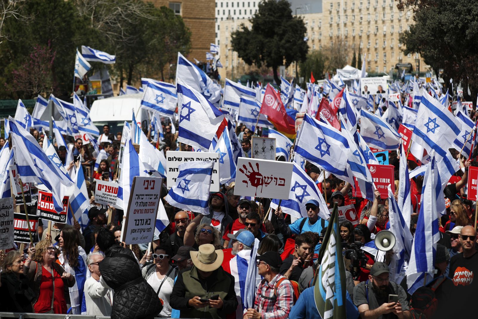 epa10545111 Protesters gather outside the Knesset ahead of mass protests in Jerusalem, Israel, 27 March 2023. Mass protests have been held in Israel for 12 weeks against the government's plans to reform the justice system and limit the power of the Israeli Supreme Court.  EPA/ATEF SAFADI